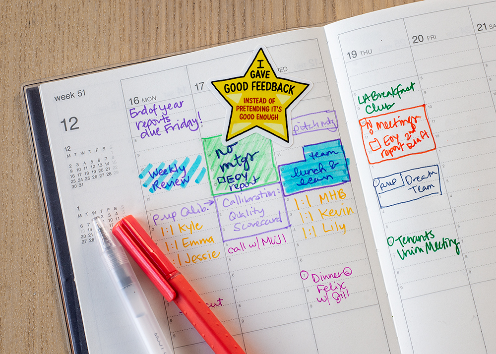 Yellow star sticker stuck in busy day planner